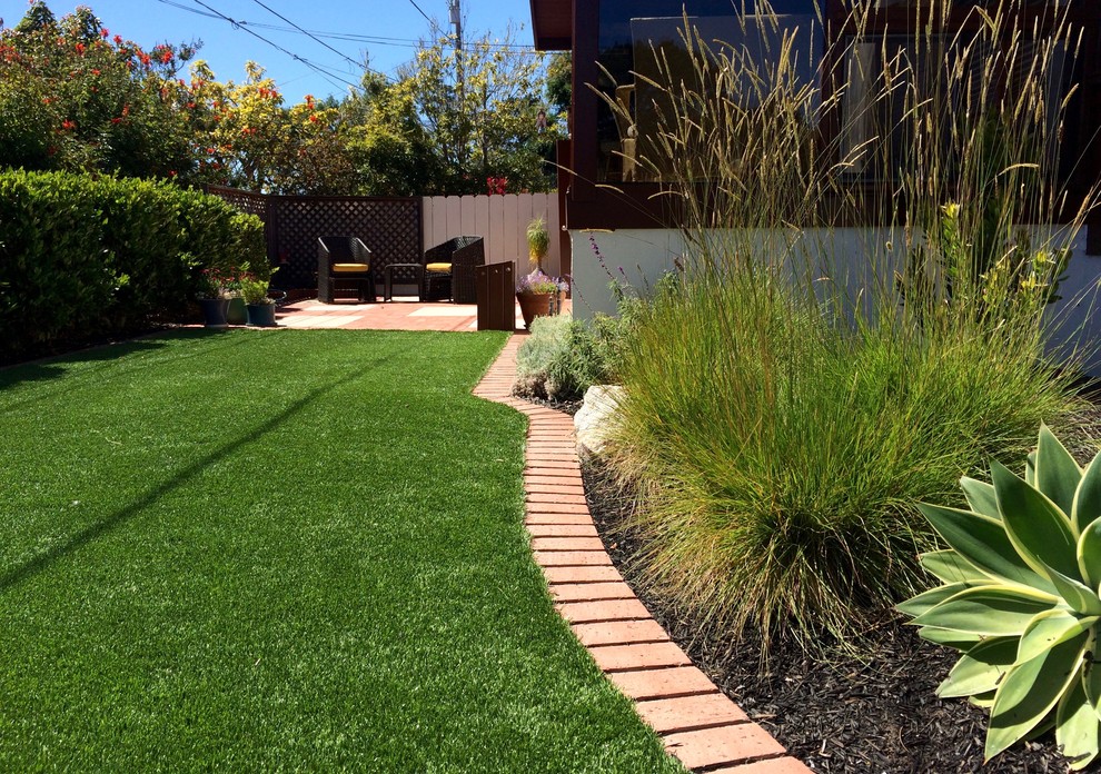 Design ideas for a mid-sized traditional partial sun backyard mulch formal garden in San Luis Obispo for spring.