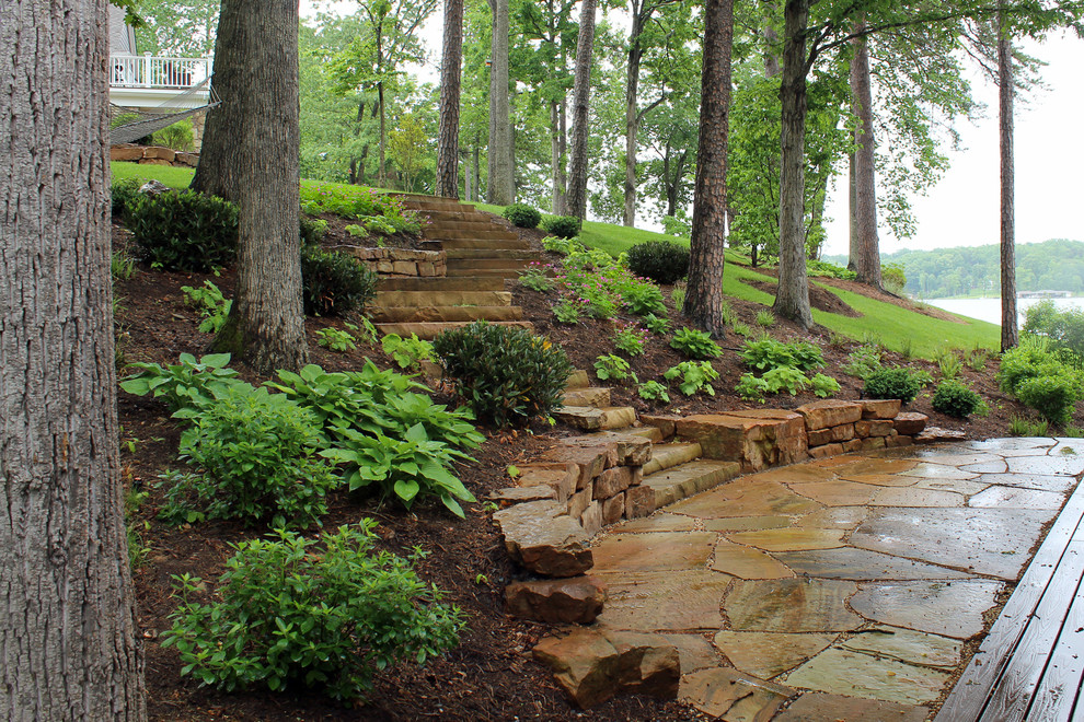 Design ideas for a mid-sized coastal partial sun hillside stone retaining wall landscape in DC Metro for spring.