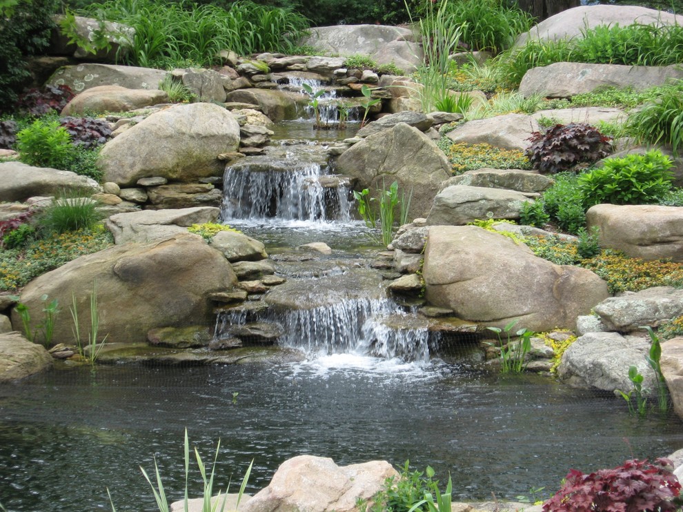 Ispirazione per un giardino classico esposto in pieno sole dietro casa con fontane e pavimentazioni in pietra naturale