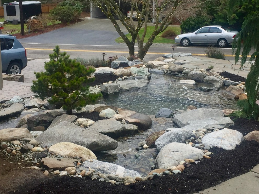 Design ideas for a large asian full sun front yard stone pond in Seattle for summer.