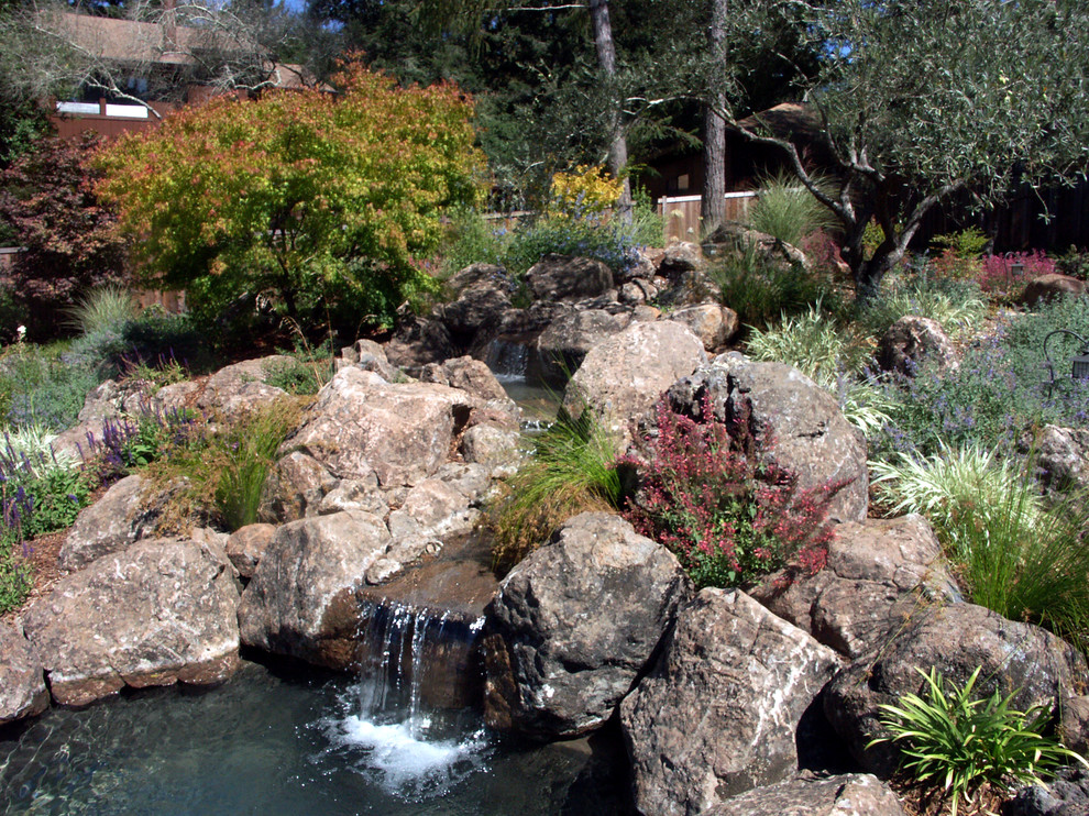 This is an example of a large traditional full sun backyard water fountain landscape in San Francisco for fall.