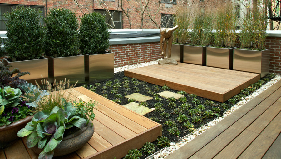 Inspiration for a mid-sized contemporary rooftop landscaping in New York with decking.