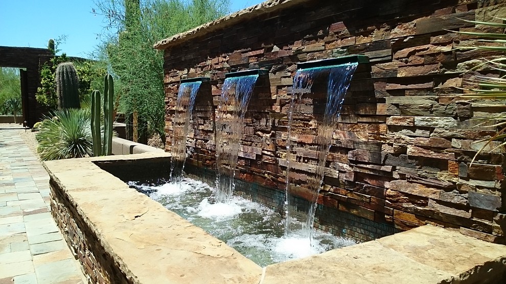 Design ideas for a large rustic full sun backyard stone water fountain landscape in Phoenix.