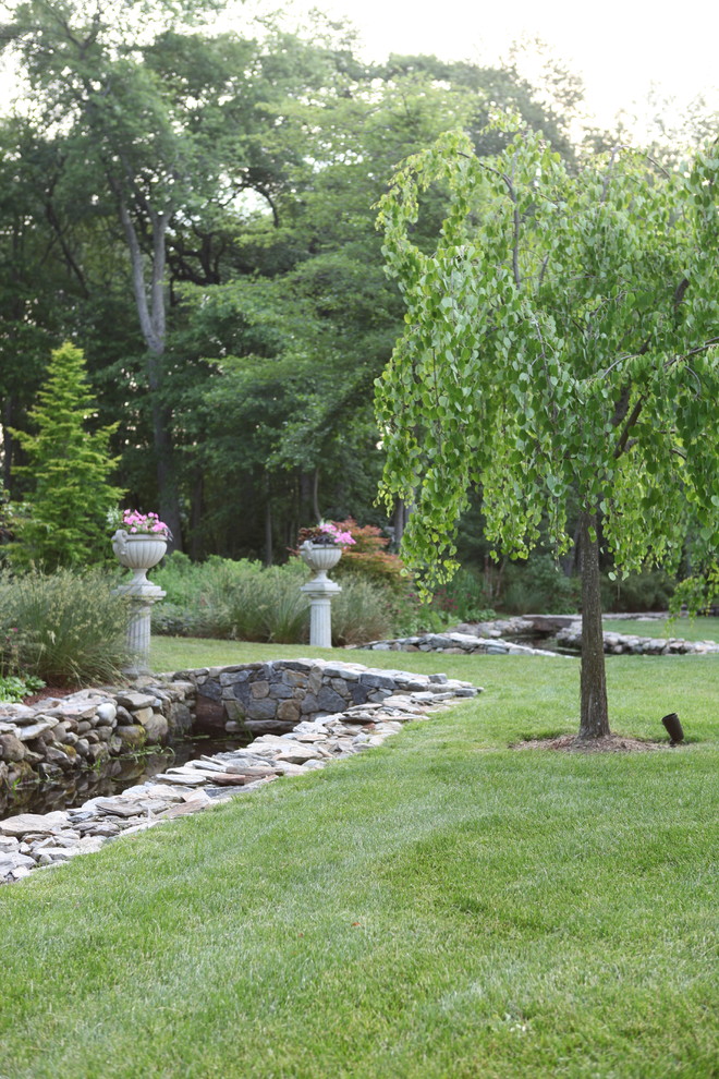 Photo of a large traditional partial sun backyard gravel formal garden in New York.