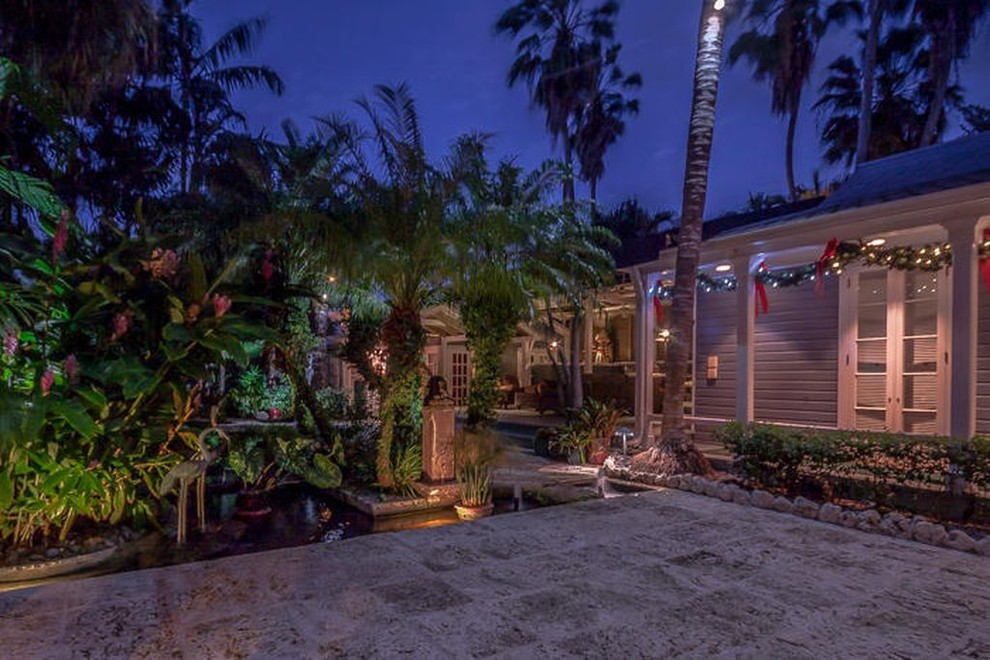 Design ideas for a large tropical full sun courtyard stone formal garden in Miami.