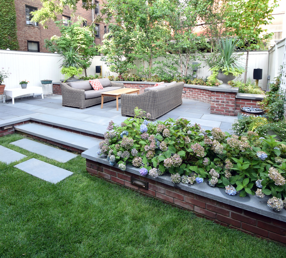 Design ideas for a large modern back garden in New York with a potted garden and concrete paving.