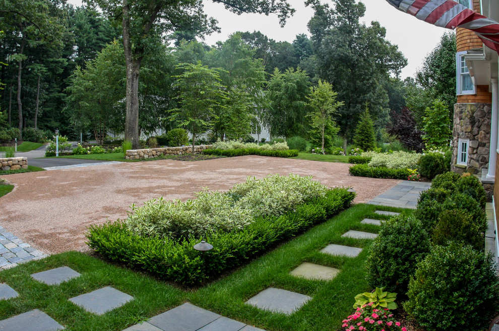 This is an example of a large traditional full sun courtyard gravel driveway in Boston.