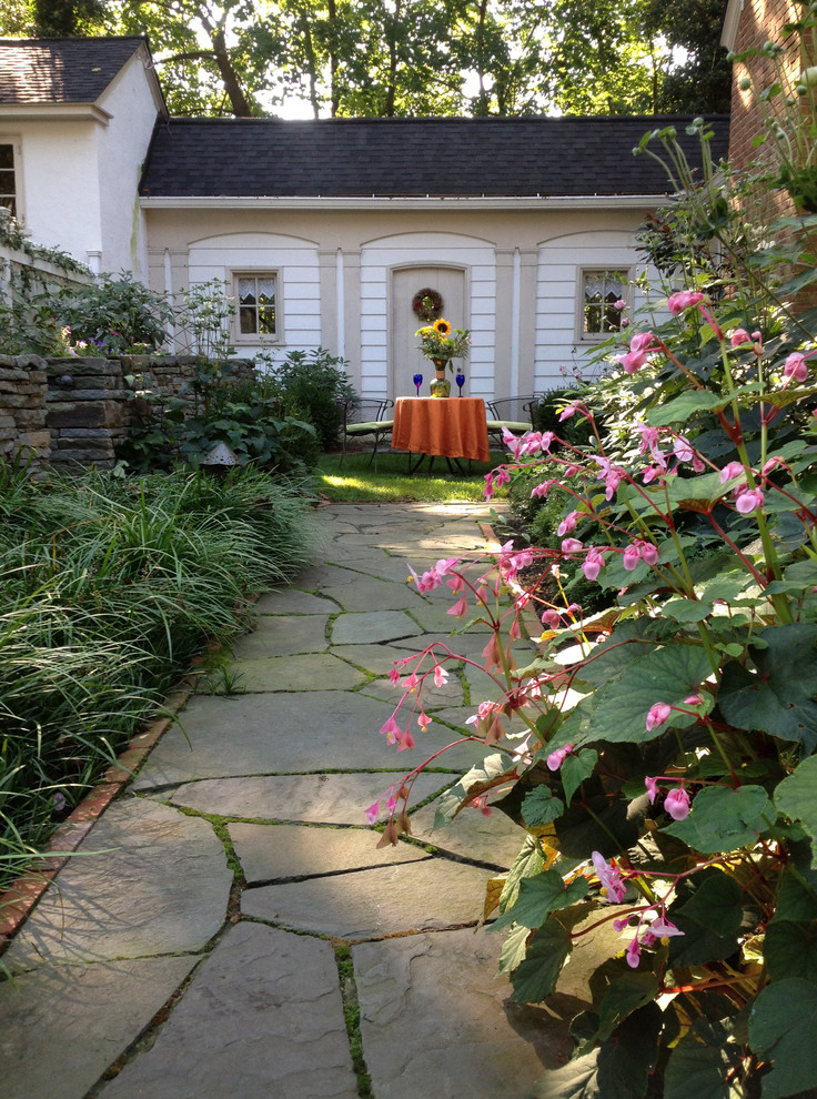 Classic fully shaded garden in Philadelphia with natural stone paving.