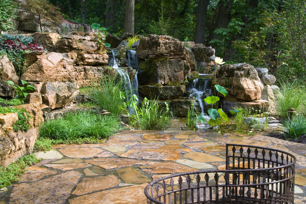 This is an example of a large rustic backyard pond in Chicago.
