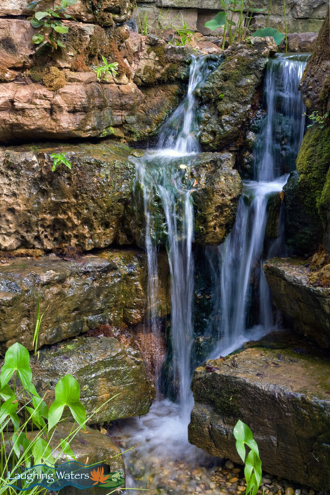 Photo of a large rustic backyard water fountain landscape in Chicago.
