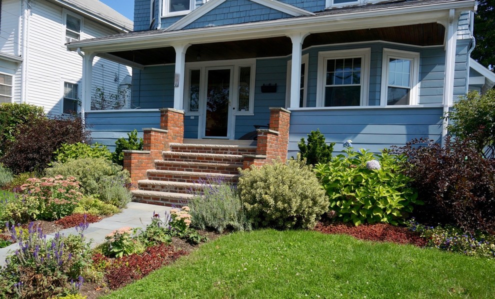 Design ideas for a mid-sized traditional partial sun front yard brick landscaping in Boston.