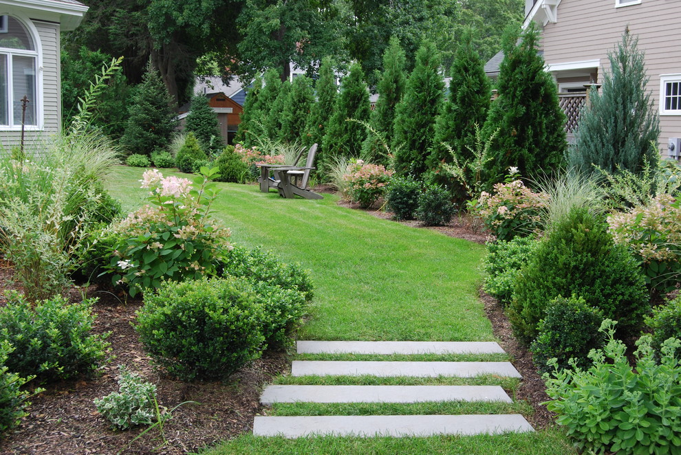 Inspiration for a mid-sized traditional full sun front yard stone landscaping in Boston.