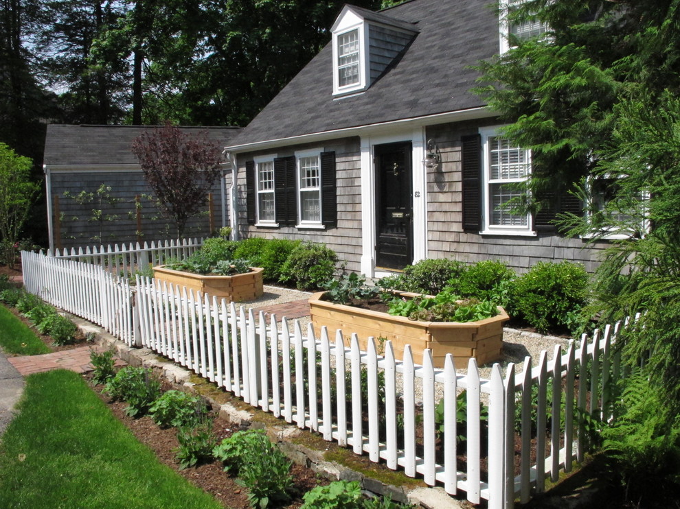 This is an example of a small traditional full sun front yard brick landscaping in Boston for summer.