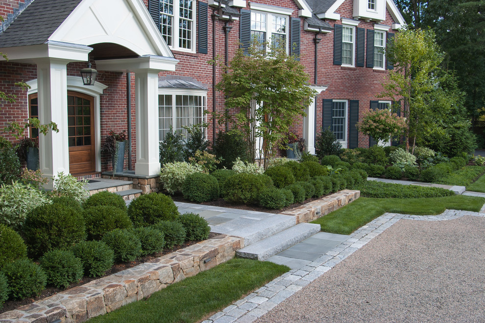 Inspiration for a large traditional full sun courtyard stone formal garden in Boston.