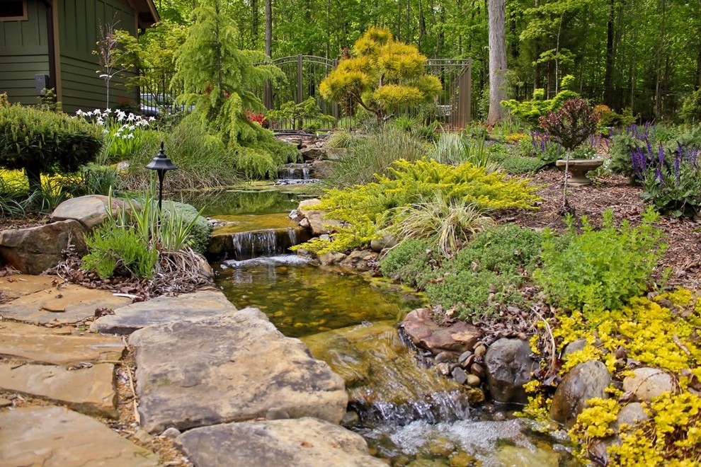 Design ideas for a large contemporary partial sun backyard water fountain landscape in Raleigh.