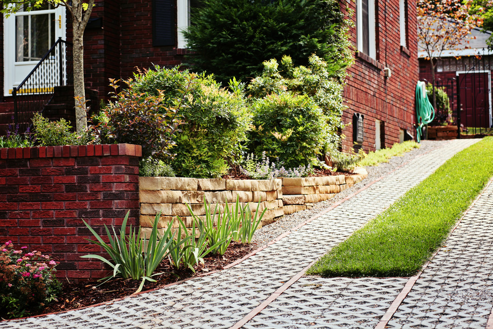 Inspiration for a small traditional front driveway full sun garden for summer in Charlotte with concrete paving.