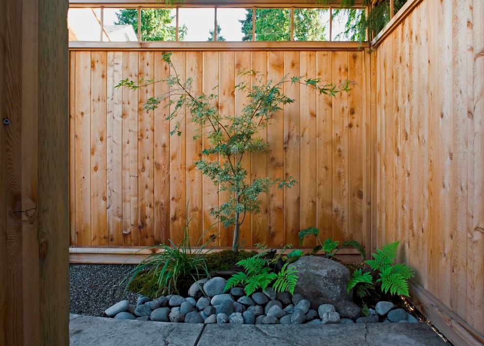 Photo of a large asian partial sun courtyard stone landscaping in Vancouver.