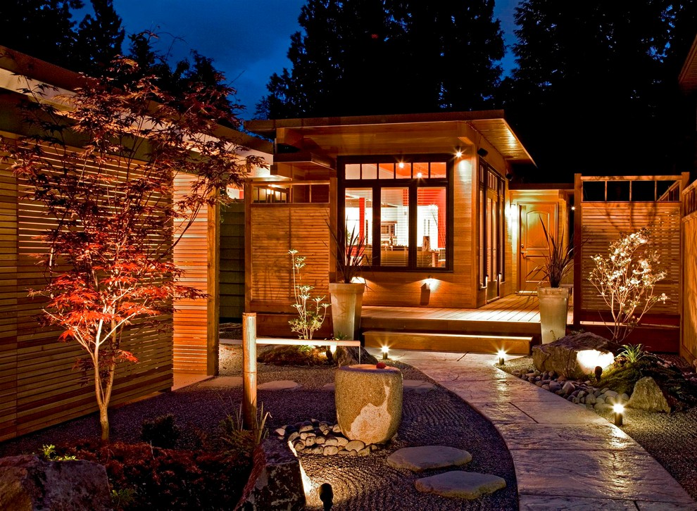 Inspiration for a large asian partial sun front yard concrete paver landscaping in Vancouver.
