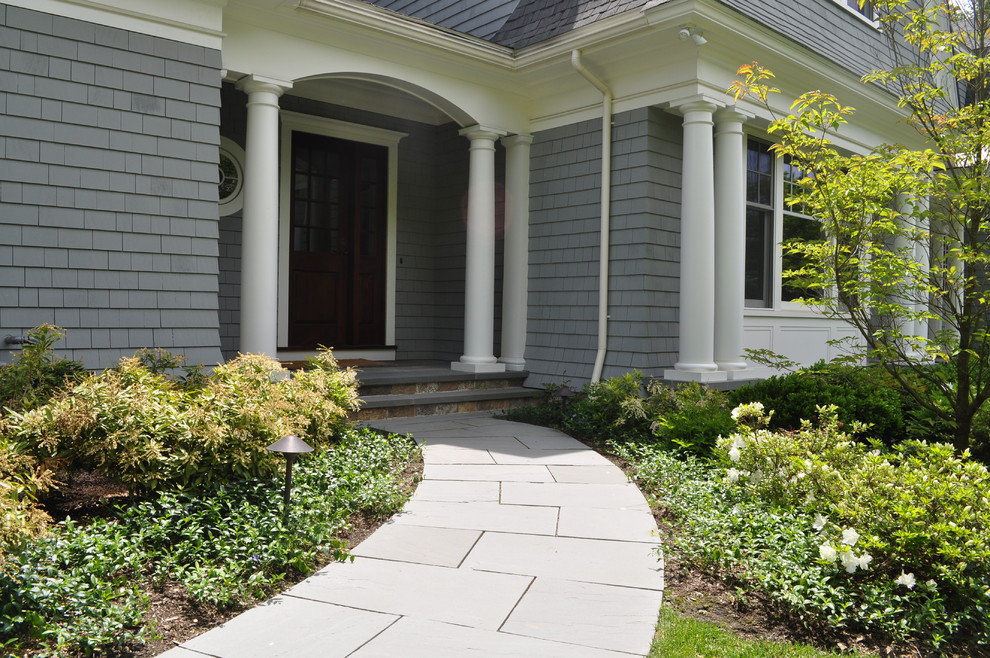 Inspiration for a medium sized traditional front partial sun garden for winter in Boston with natural stone paving.