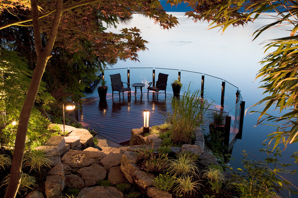 Inspiration for a sloped formal partial sun garden for summer in Vancouver with decking.