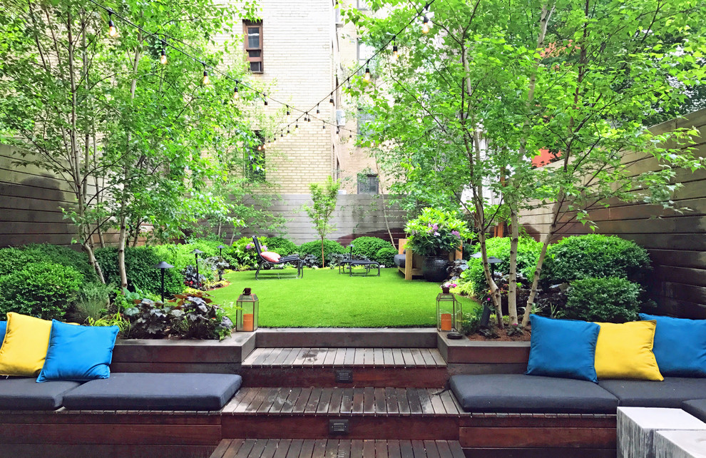 This is an example of an eclectic back partial sun garden for spring in New York with decking.