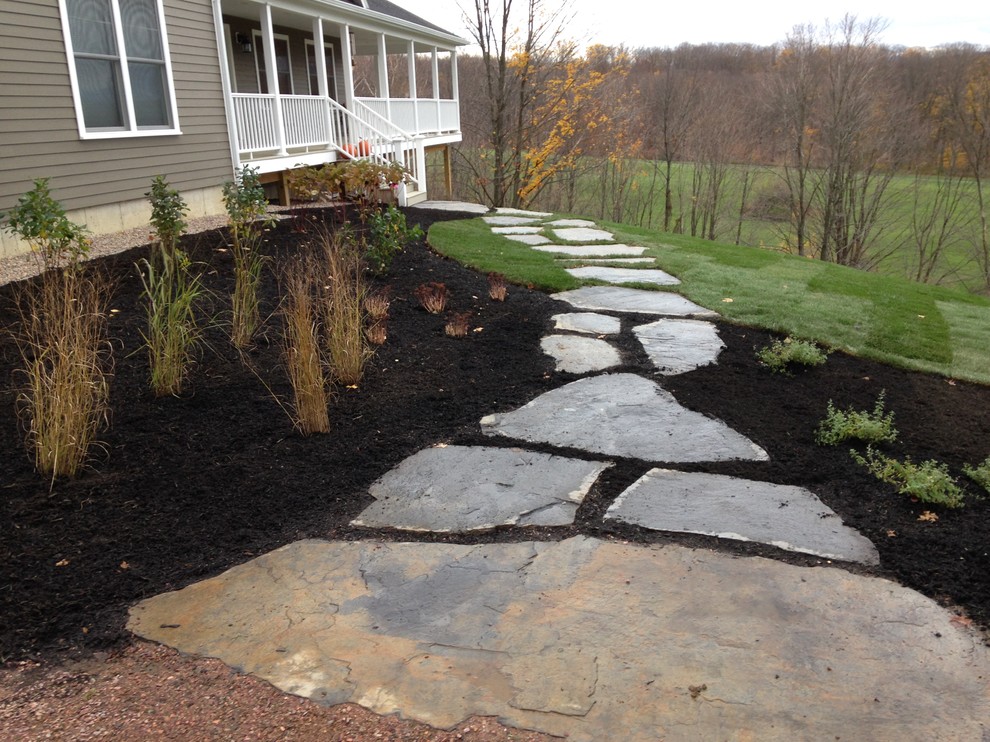 Design ideas for a large classic front full sun garden in Burlington with a garden path and natural stone paving.