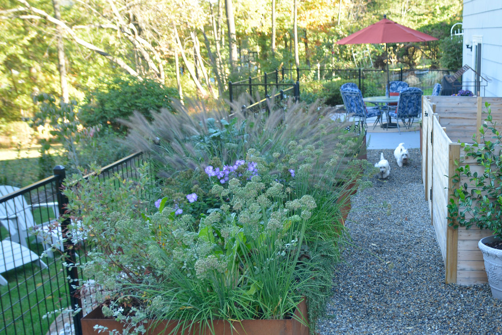 Small traditional side partial sun garden in New York with a vegetable patch and gravel.