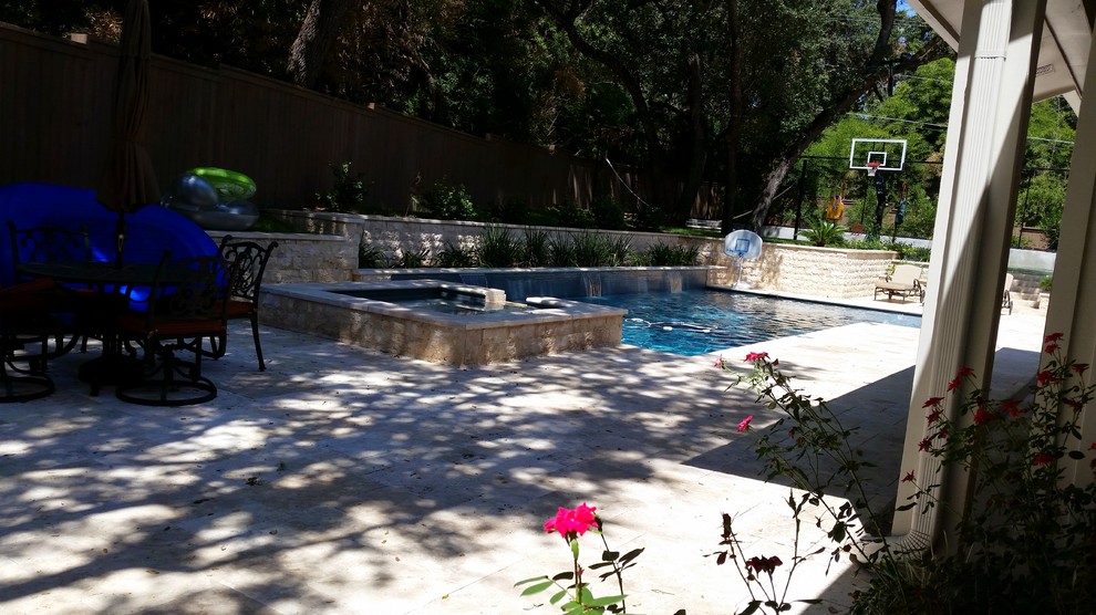 Design ideas for a large transitional shade backyard stone landscaping in Austin for spring.