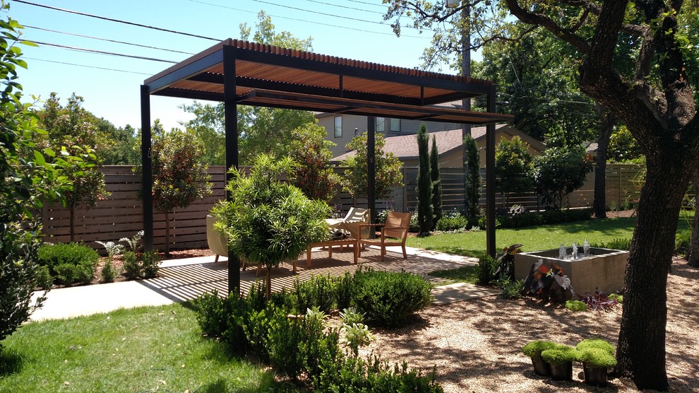 Photo of a mid-sized modern backyard landscaping in Austin.