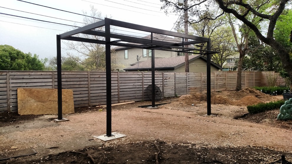 This is an example of a medium sized modern back garden in Austin.