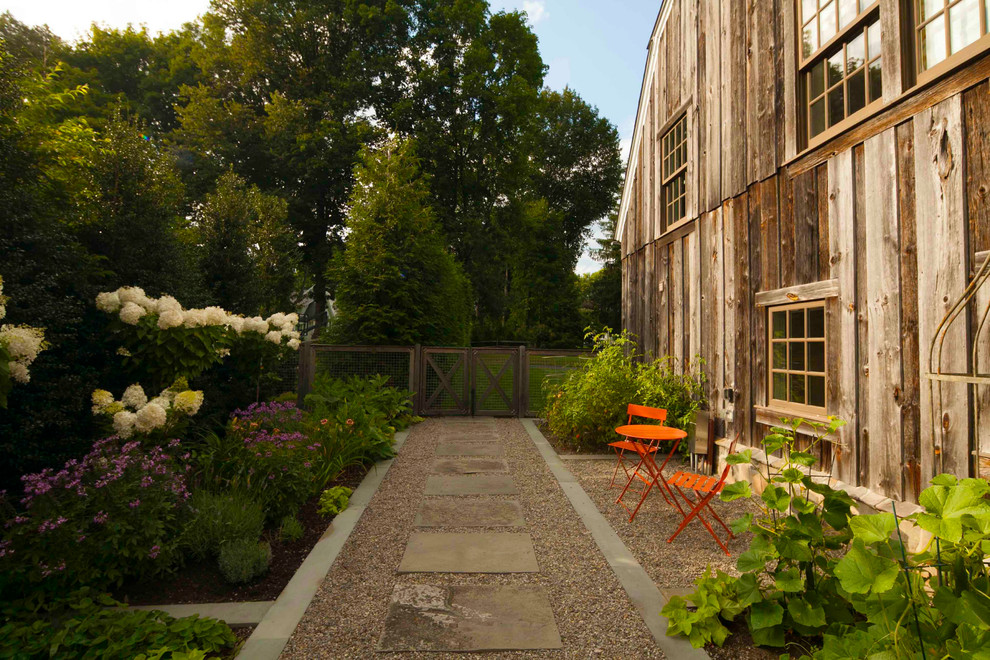 Photo of a small farmhouse side yard vegetable garden landscape in New York.