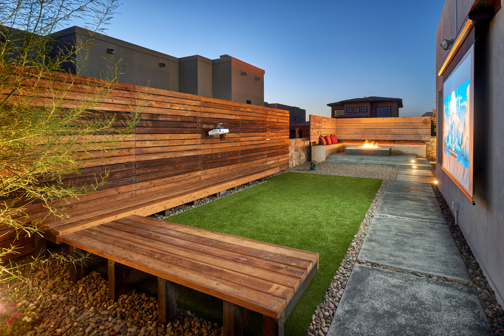 Design ideas for a contemporary back garden in Other with a fire feature and concrete paving.