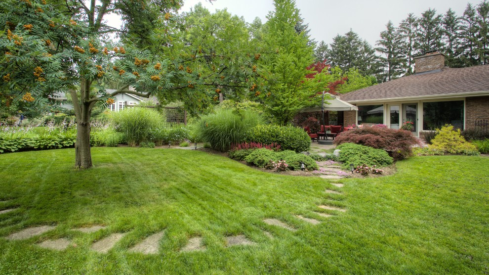 Photo of an expansive eclectic back formal full sun garden for summer in Toronto with a garden path and mulch.
