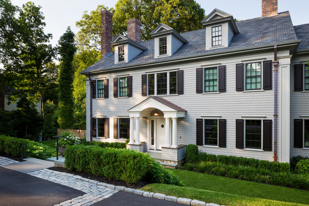 Photo of a contemporary front driveway full sun garden in Boston with natural stone paving.