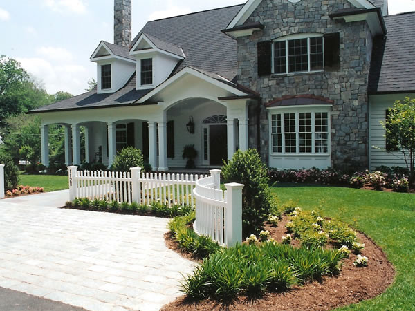 This is an example of a medium sized classic front driveway garden in DC Metro with natural stone paving.