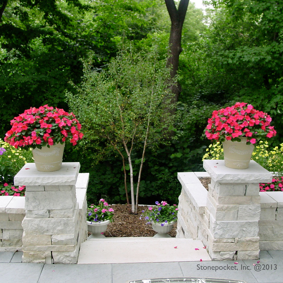 Inspiration for a mid-sized traditional full sun backyard stone landscaping in Minneapolis.
