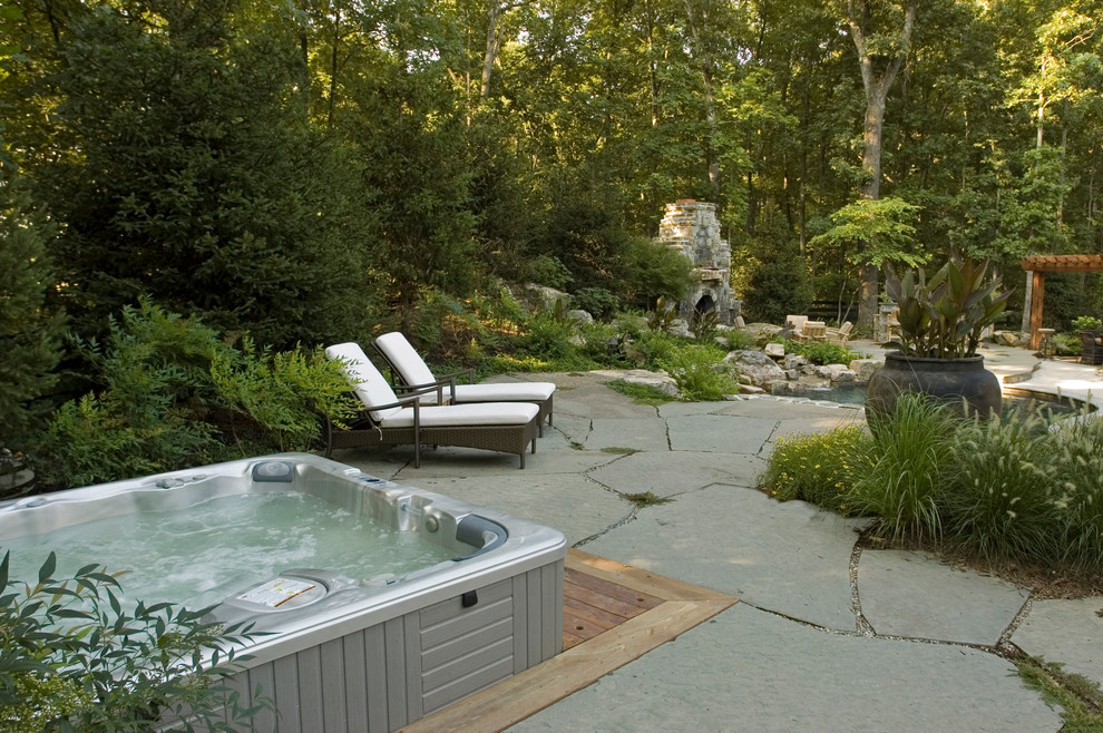 Photo of a mid-sized rustic partial sun backyard gravel landscaping in DC Metro.