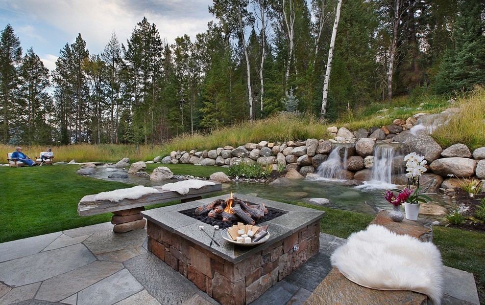 Inspiration for a rustic back garden in Other with a fire feature.