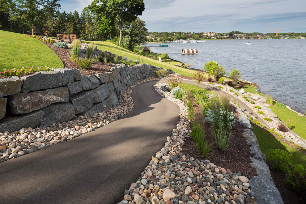 Design ideas for a large coastal back full sun garden for summer in Minneapolis with a retaining wall.