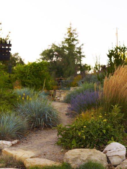 Inspiration for a large mediterranean drought-tolerant and partial sun backyard stone landscaping in San Luis Obispo.