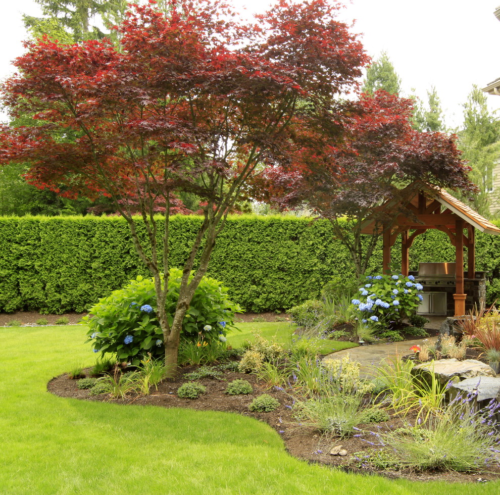 Photo of a large classic back formal garden wall in Seattle with natural stone paving.