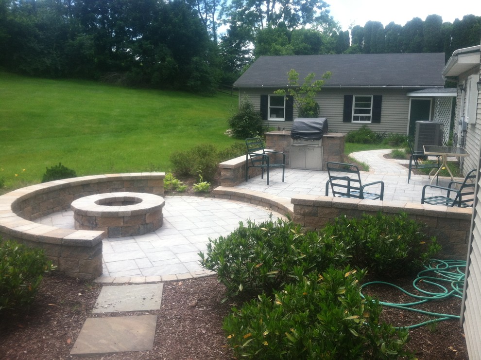 This is an example of a mid-sized traditional full sun backyard concrete paver landscaping in Philadelphia for summer.
