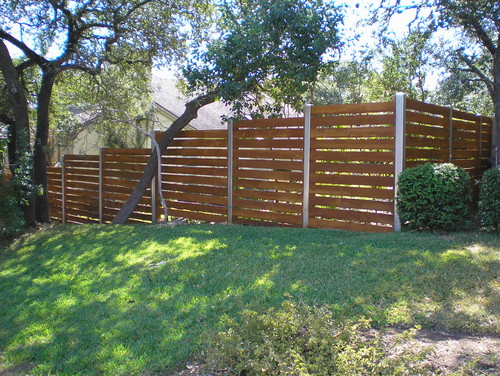 yard with a wood slot fence on a hill 