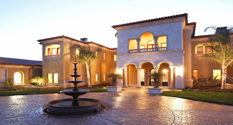 Inspiration for a large mediterranean front yard concrete paver driveway in Tampa.