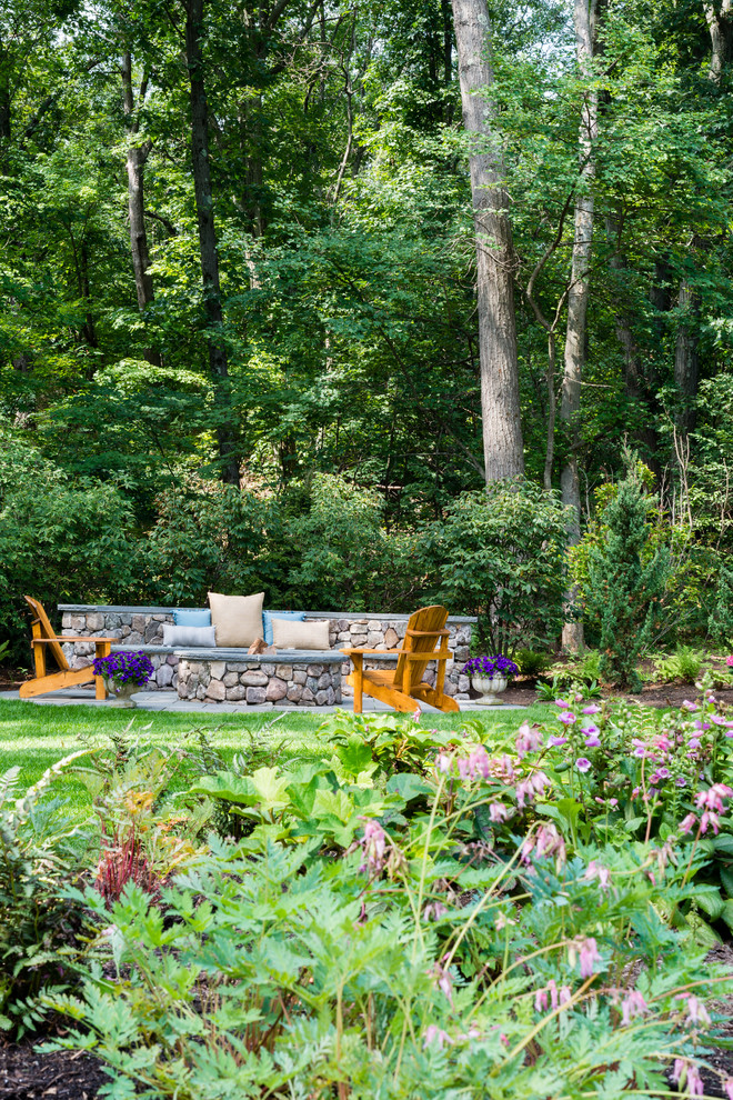 Ejemplo de jardín de estilo de casa de campo de tamaño medio en verano en patio trasero con jardín francés, brasero, exposición parcial al sol y adoquines de piedra natural