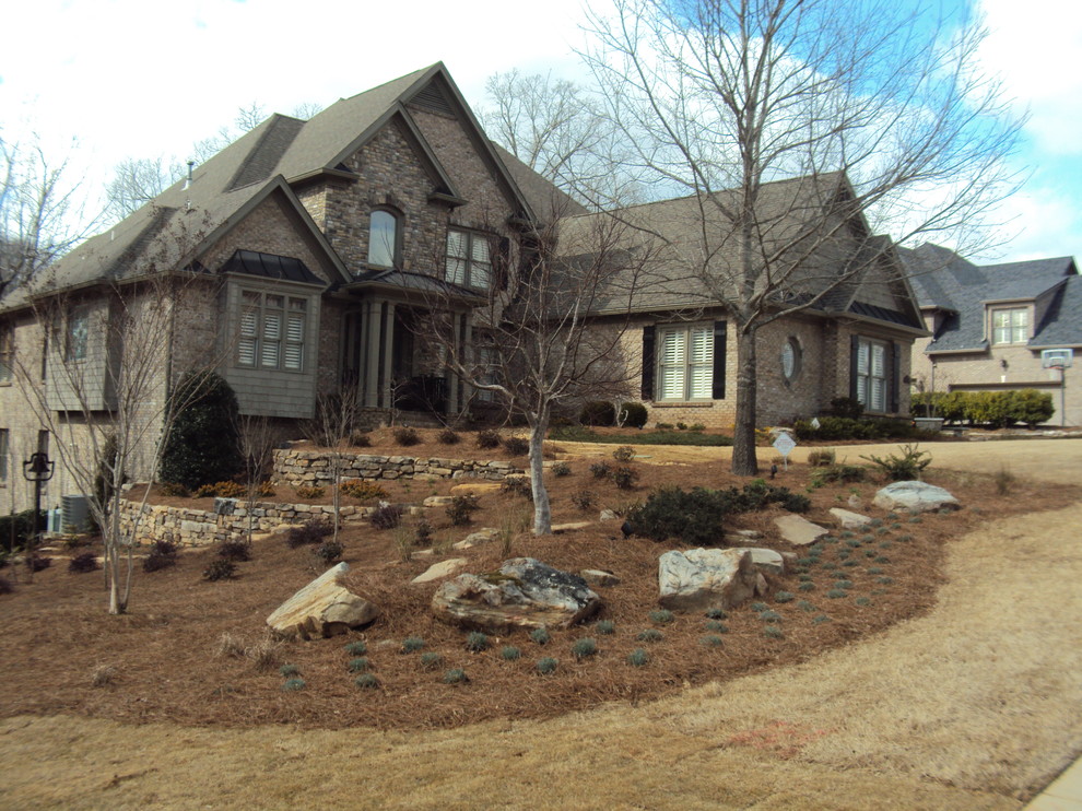 Inspiration for a large traditional front xeriscape full sun garden in Atlanta with a retaining wall.