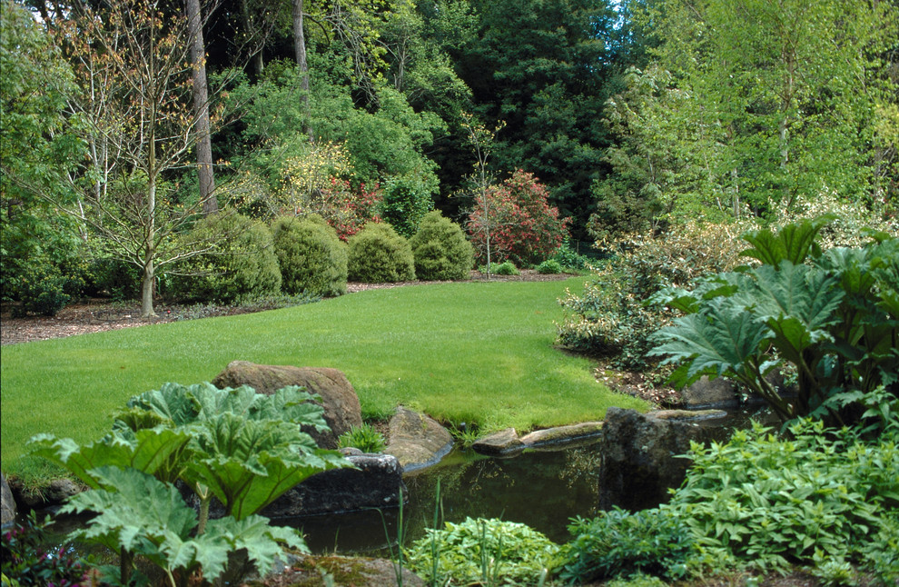 Aménagement d'un très grand jardin arrière classique avec un point d'eau et une exposition ensoleillée.