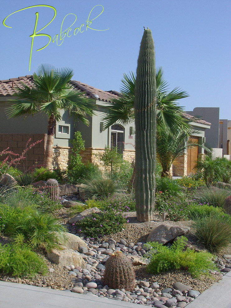 This is an example of a small southwestern drought-tolerant, desert and full sun front yard brick and stone fence landscaping in Other for summer.