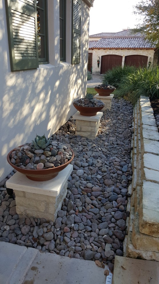 Inspiration for a small contemporary side xeriscape fully shaded garden in Austin with a potted garden and gravel.