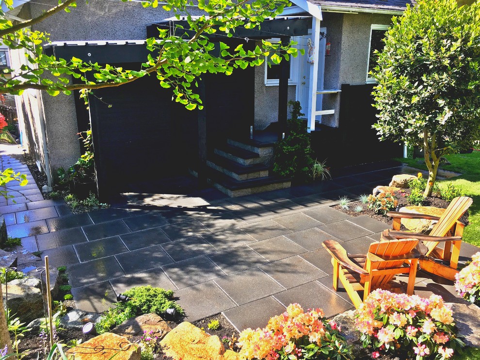 Modelo de jardín minimalista en patio trasero con adoquines de hormigón